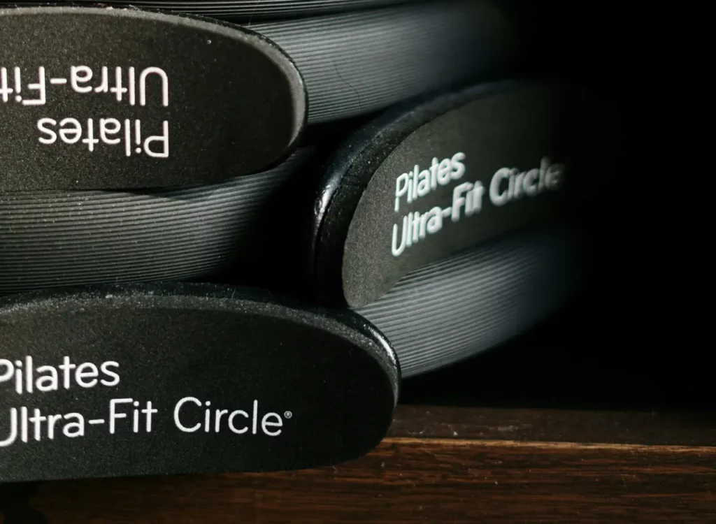 Close-up of Pilates Ultra-Fit Circles neatly stacked in a fitness center.